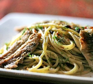 Spaghetti with fresh anchovies on a plate