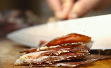 A close up of venison ham slices