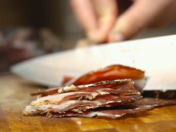 A close up of venison ham slices