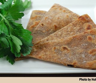 Wedges of acorn flatbread on a plate.