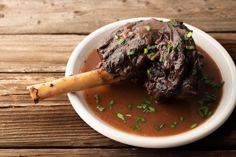 Portuguese braised venison shanks on a plate