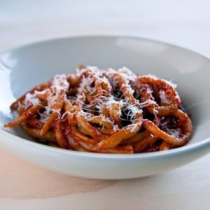 Pici pasta served with fennel tomato sauce in a bowl.