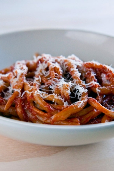 Pici pasta served with fennel tomato sauce in a bowl.
