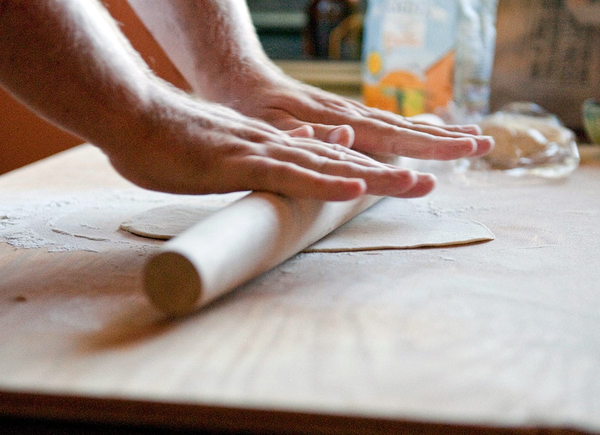 Rolling pasta dough about 1/8 inch thick. 