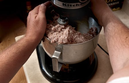 mixing venison sausages