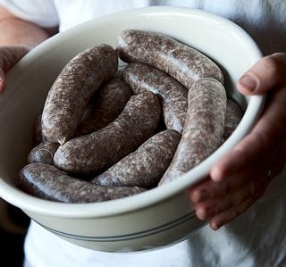 A bowl of venison sausages