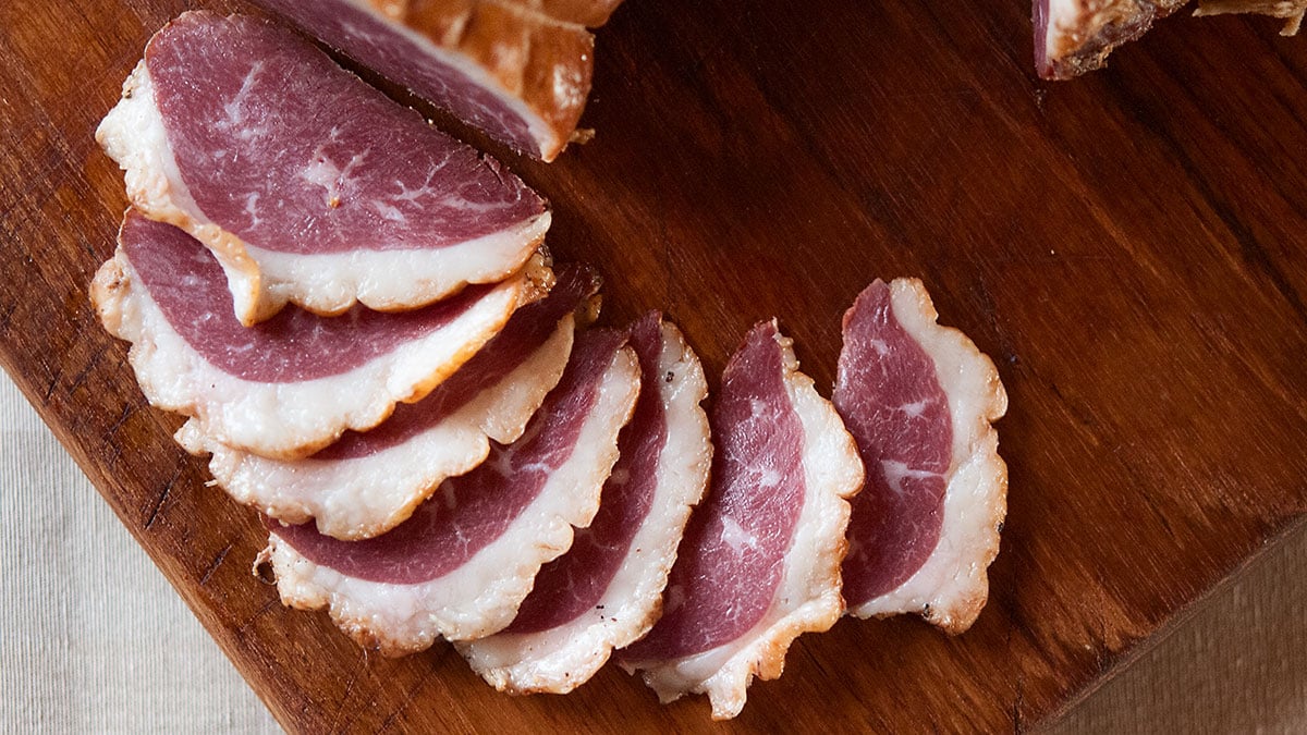 German smoked goose breast on a cutting board