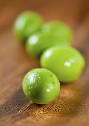 Raw green olives on a table. 