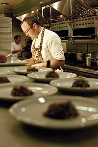 A group of people preparing food in a kitchen, with Hank Shaw