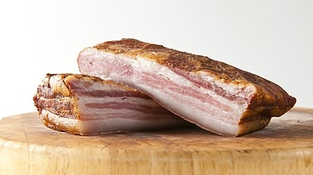 Slices of Chinese bacon on a cutting board