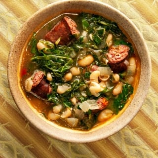 A bowl of kale soup with linguica.