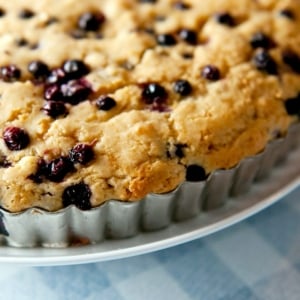 Close up of huckleberry cake in a tart pan.