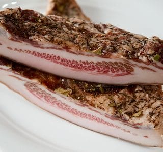 Slices of guanciale on a plate.