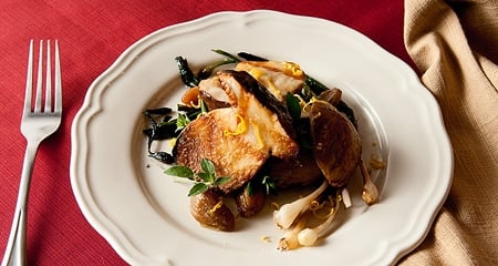 A plate of grilled porcini with spring vegetables. 