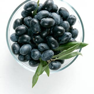 Fresh black olives in a bowl ready to be oil cured