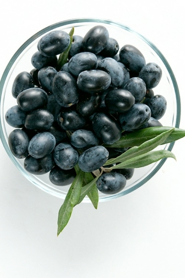 Fresh black olives in a bowl ready to be oil cured