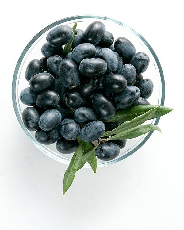 Fresh black olives in a bowl ready to be oil cured