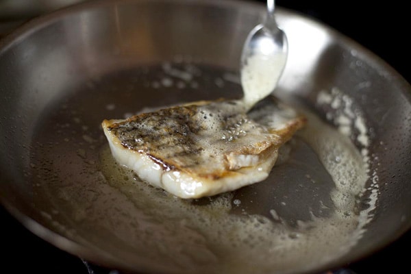 Basting skin of fish with butter