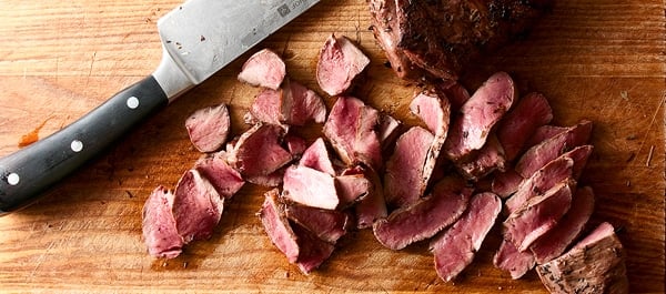 sliced venison heart on a cutting board