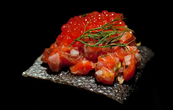 Closeup of the salmon tartare recipe, on a crispy salmon skin chip