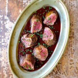 A platter of venison with Cumberland sauce.