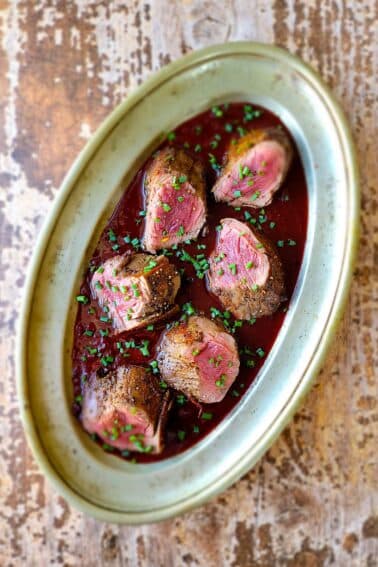 A platter of venison with Cumberland sauce.