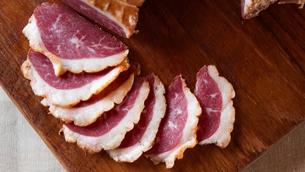 German smoked goose breast sliced on cutting board