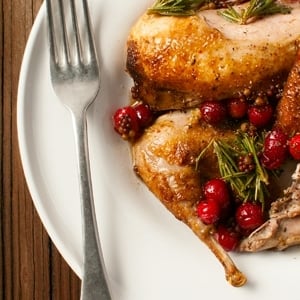 Seared partridges with cranberries and rosemary.