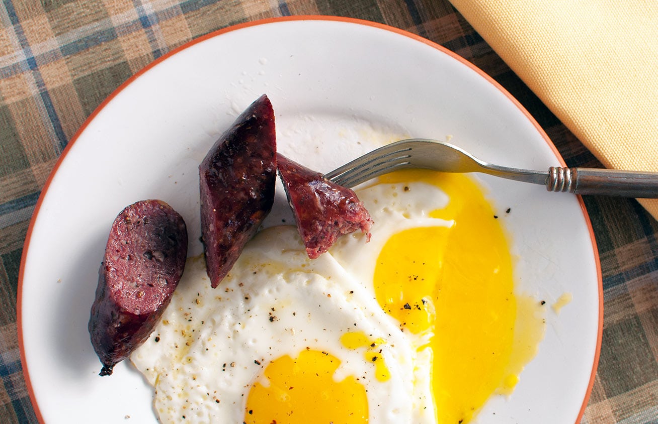 Polska kielbasa on a plate with fried eggs. 