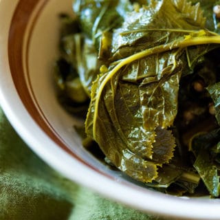 Close up of a bowl of pickled mustard greens.