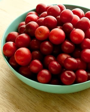 bowl of red wild plums