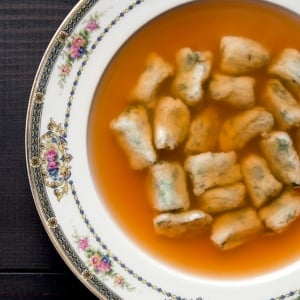 carrot consomme with dumplings in a bowl