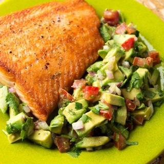 Salmon with avocado salsa on the plate