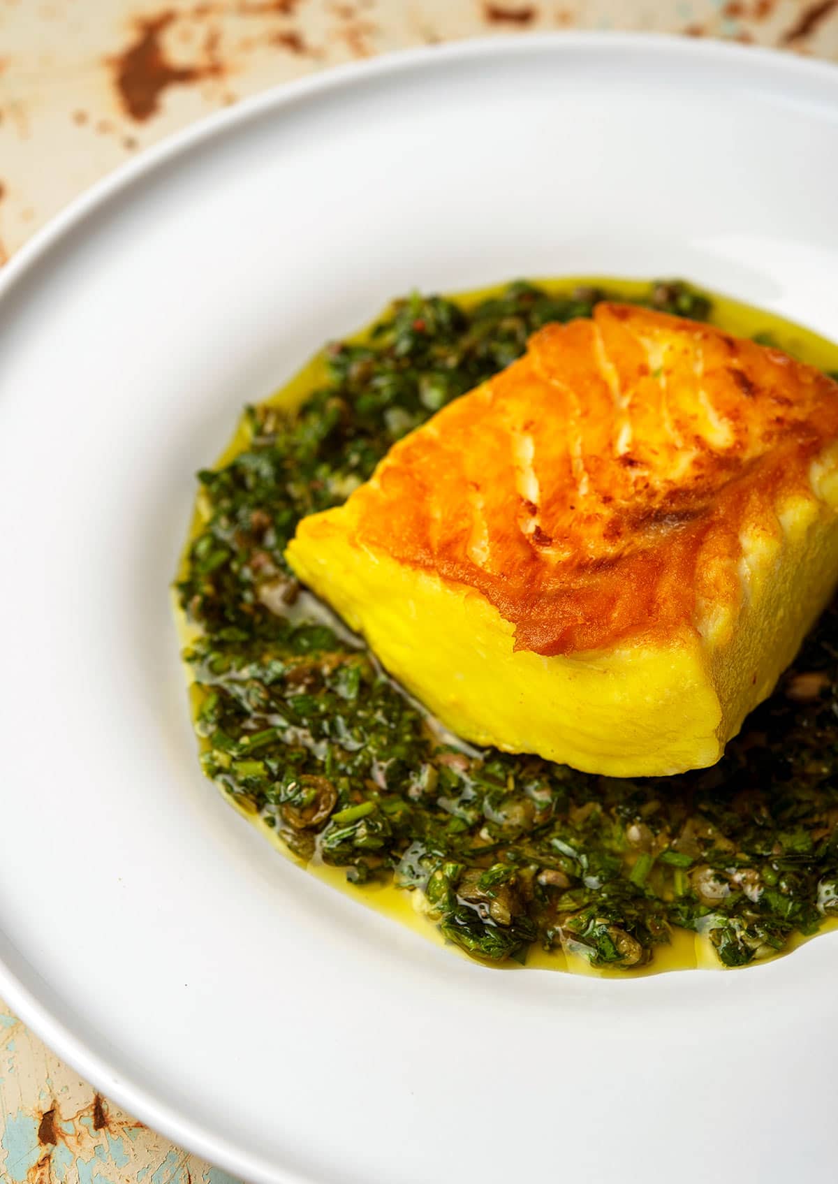 Italian salsa verde with halibut on a plate