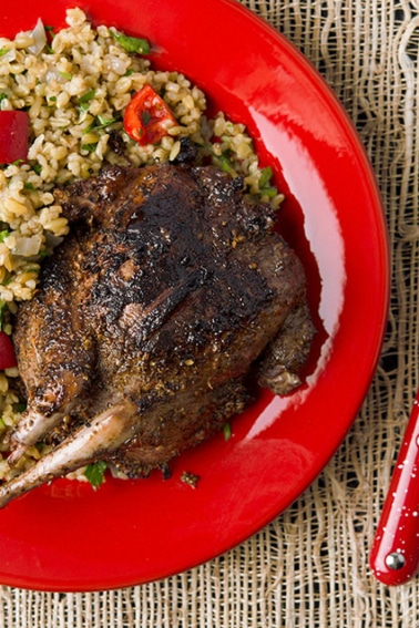 A plate of grilled pigeon with rice pilaf.