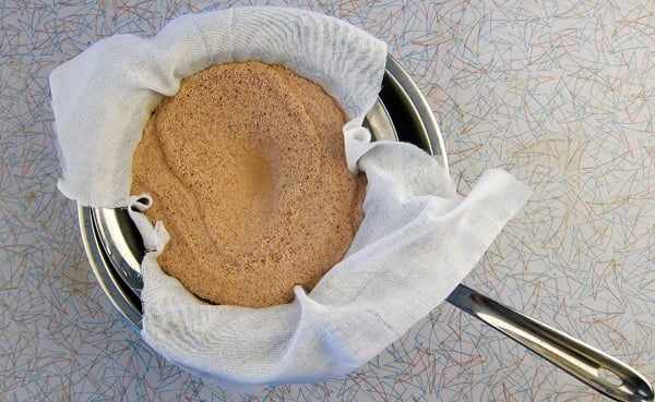 straining acorn flour