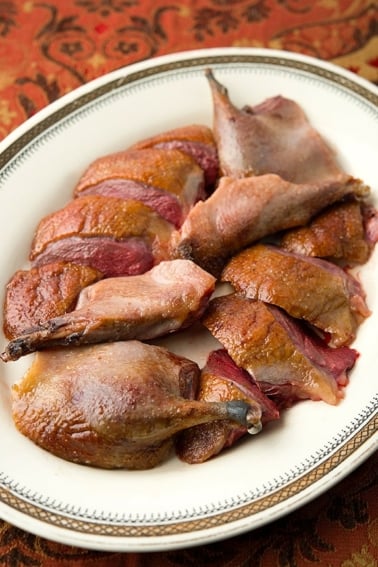 roast wild duck sliced on a platter