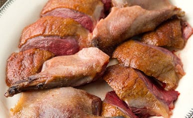 roast wild duck sliced on a platter