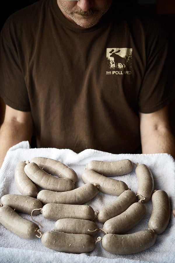 Hank Shaw holding bockwurst sausages. 