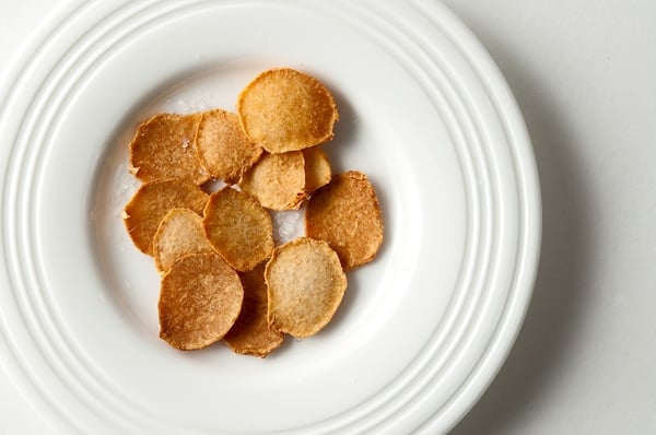 Fried groundnut chips on a plate. 