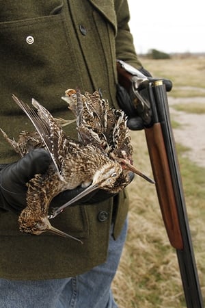 Hank Shaw holding snipe in the field