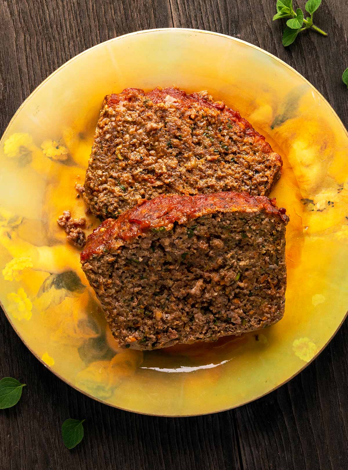 Two slices of venison meatloaf on a plate. 