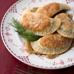 Cooked mushroom pierogi on a plate.