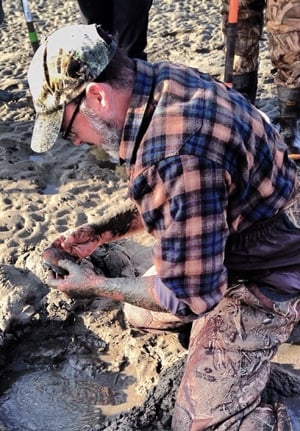 Hank Shaw, digging a clam