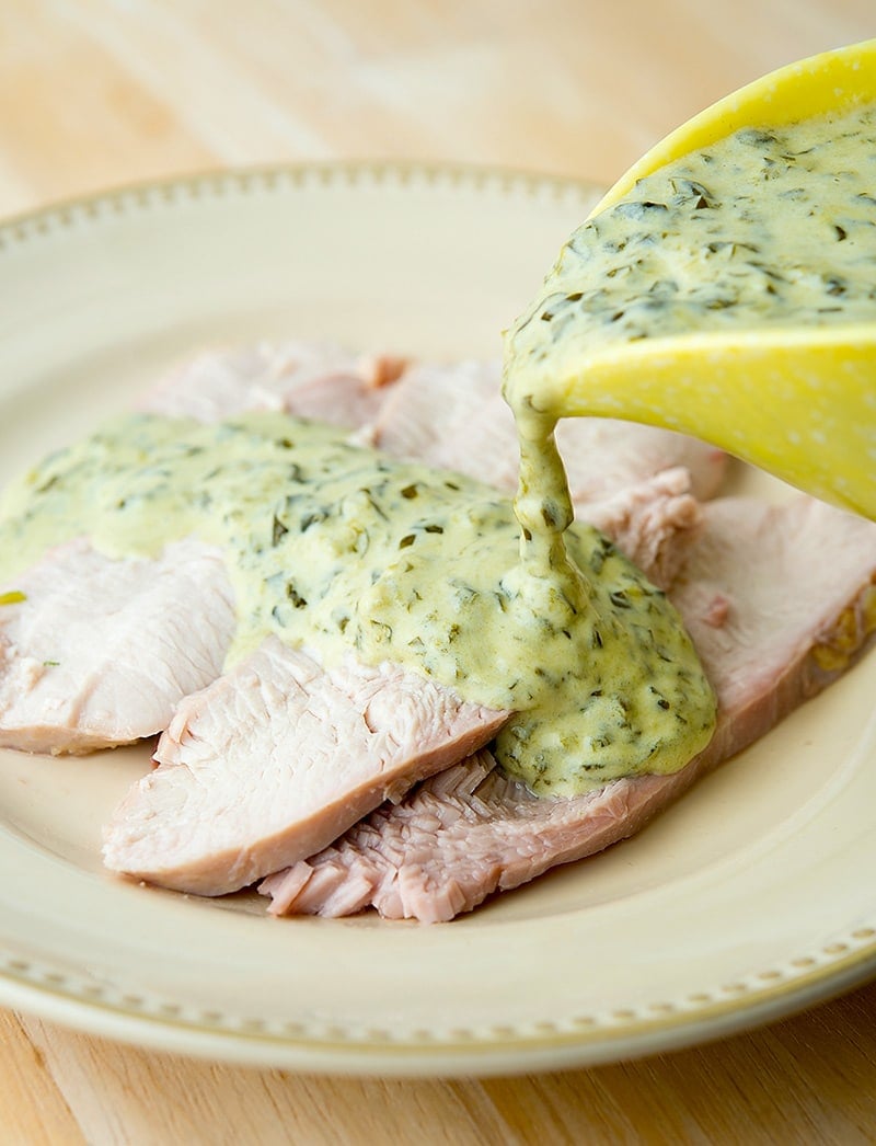 pouring sorrel sauce on turkey breast