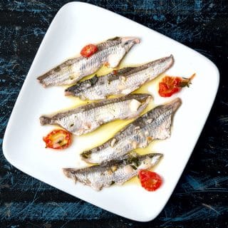 A plate of boquerones ready to eat.