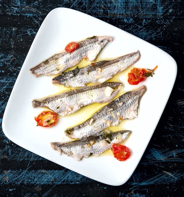 finished boquerones recipe, with fish on a plate