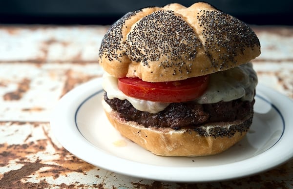 A classic venison burger, ready to eat on a plate