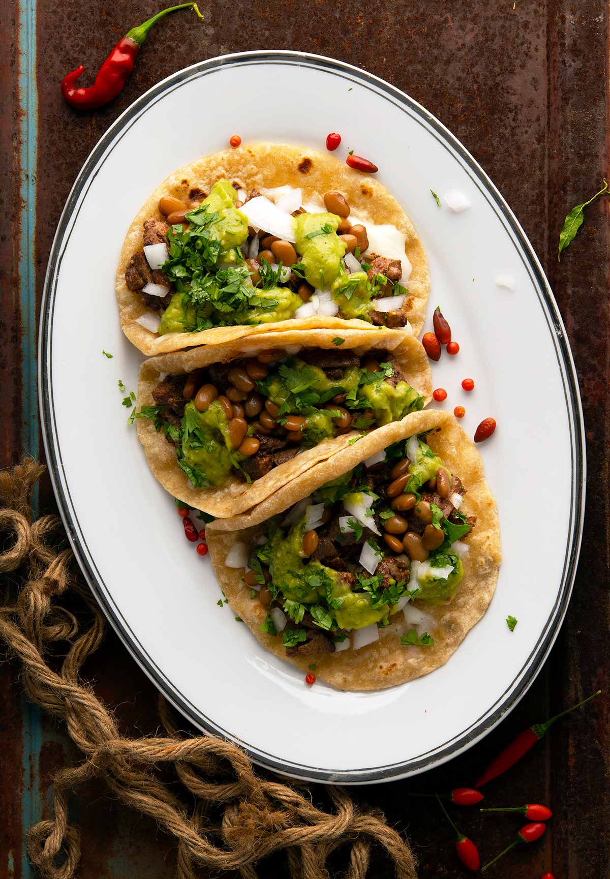 Pork rinds with guacamole on traditional Mexican comal Stock Photo