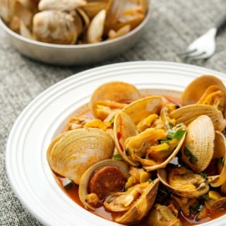 A bowl of clams and chorizo.